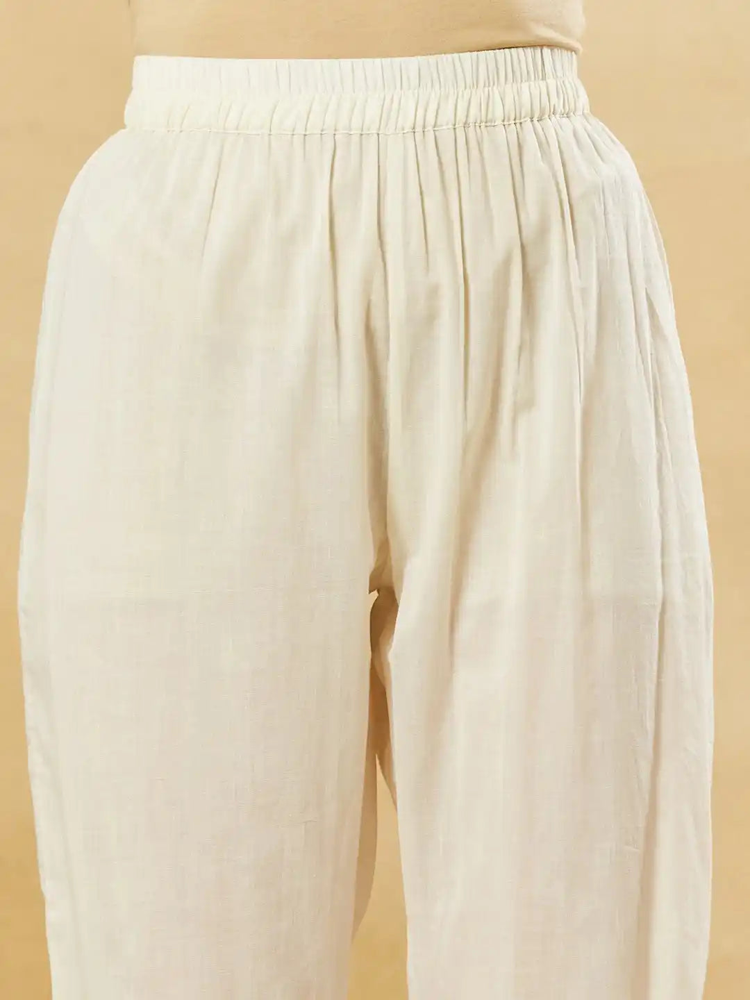 Cream white cotton palazzo pants with an elasticated waistband for comfortable ethnic wear.