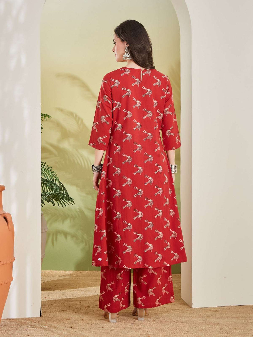 Woman in red ethnic kurta and palazzo set with gold floral print