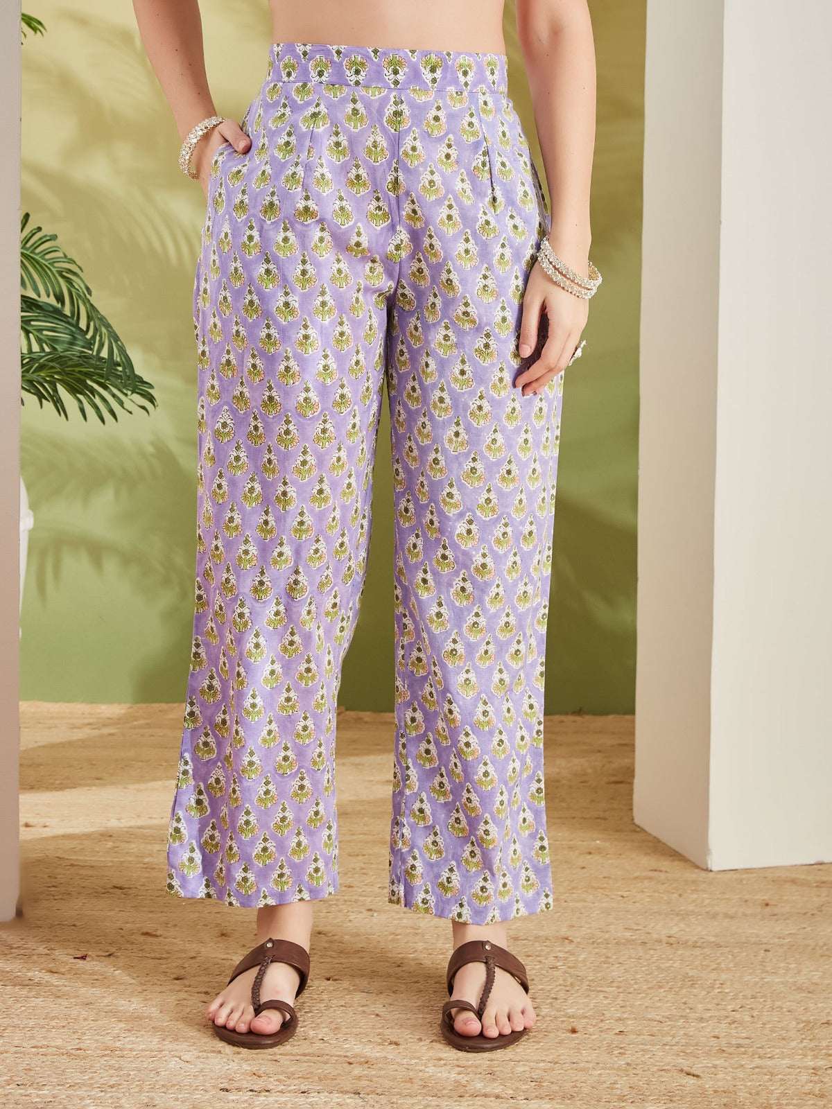 Women's lavender printed wide-leg ethnic trousers with green floral motifs.