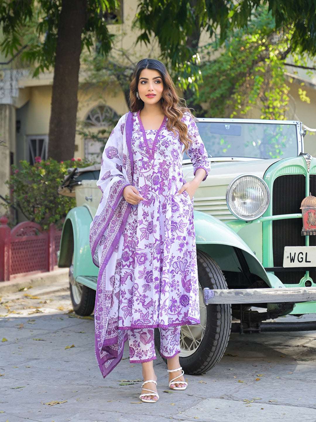 Woman in a purple and white floral printed Indian ethnic salwar kameez suit with dupatta