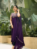 Woman wearing a purple embroidered Anarkali suit with a matching dupatta.