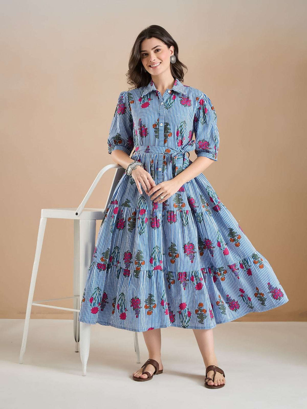 Woman in blue and white striped floral print midi dress with puff sleeves