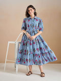 Woman in blue and white striped floral print midi dress with puff sleeves