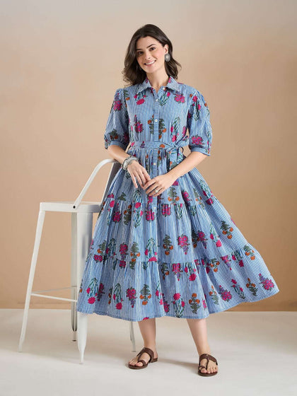 Woman in blue and white striped floral print midi dress with puff sleeves