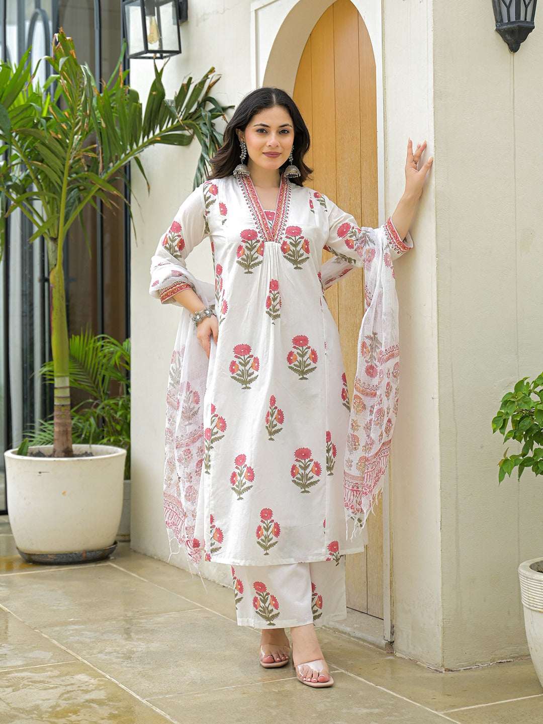 Woman wearing a white floral print cotton kurta set with dupatta in Indian ethnic style.