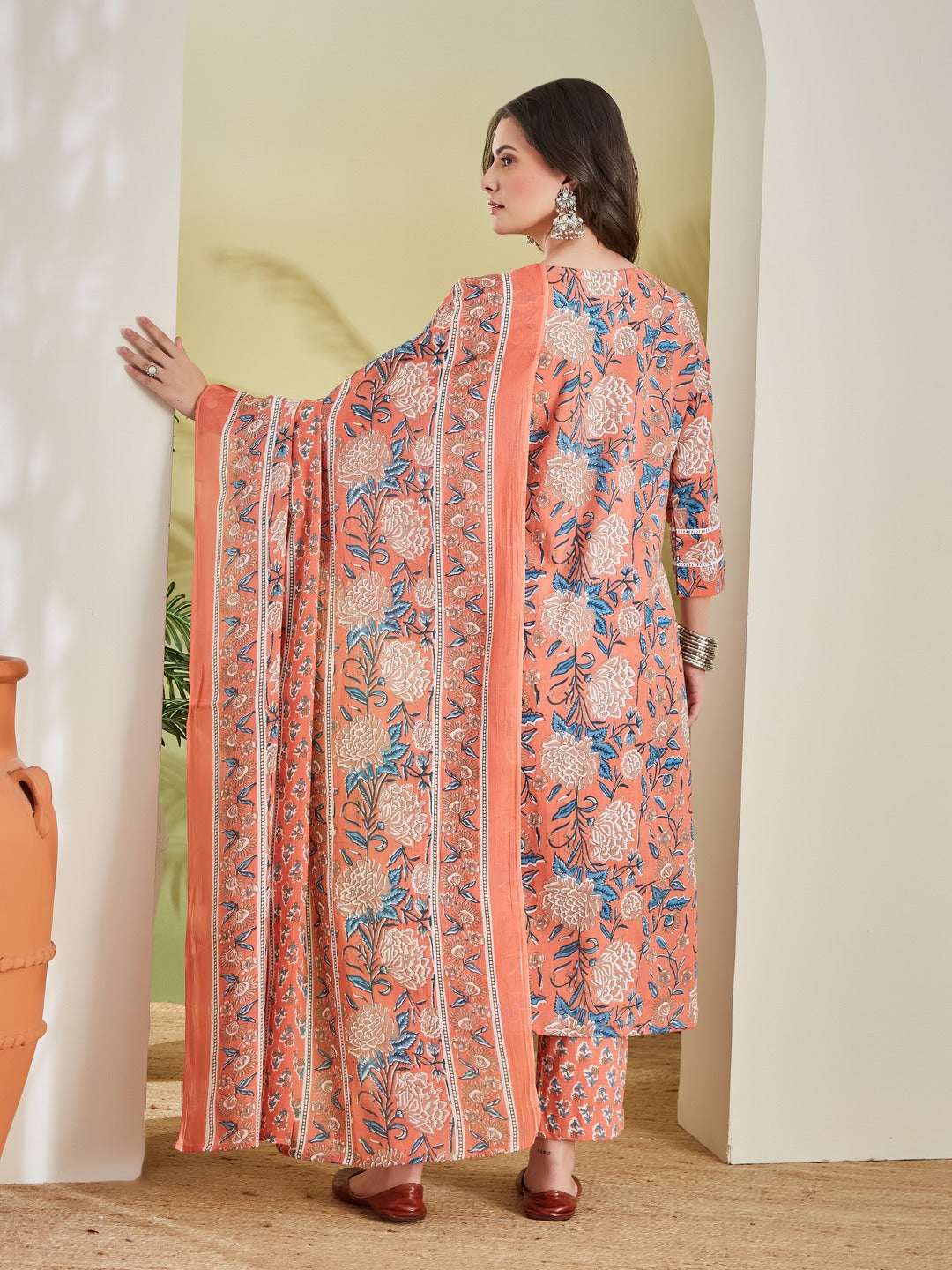 Peach floral printed kurta set with wide sleeves and matching pants, styled for casual wear
