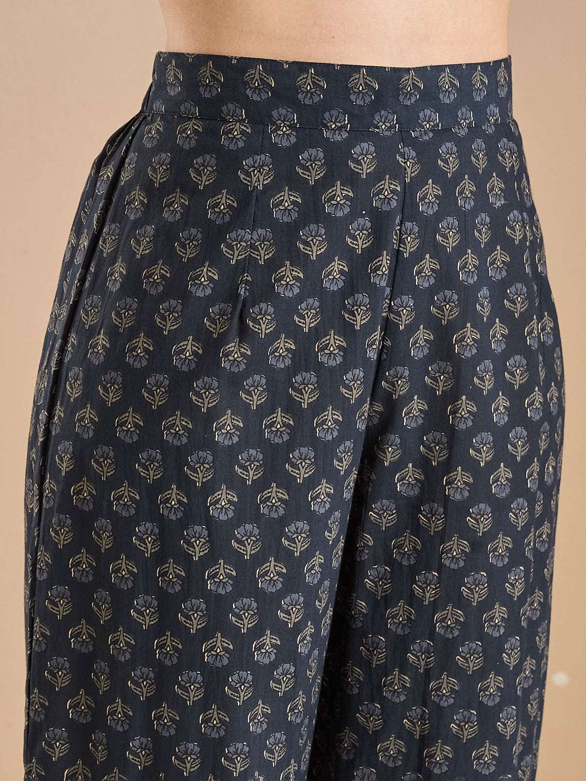 Close-up of navy blue ethnic trousers with gold floral foil print