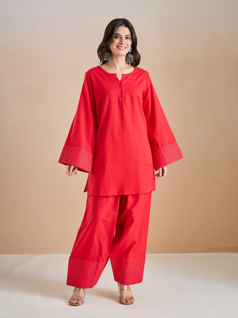 Woman wearing a red ethnic tunic and wide-leg palazzo pants set.