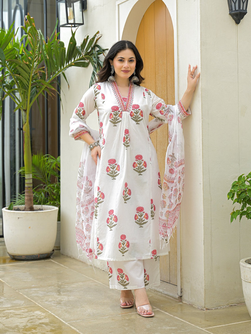 Woman wearing a white floral print cotton kurta set with dupatta in Indian ethnic style.