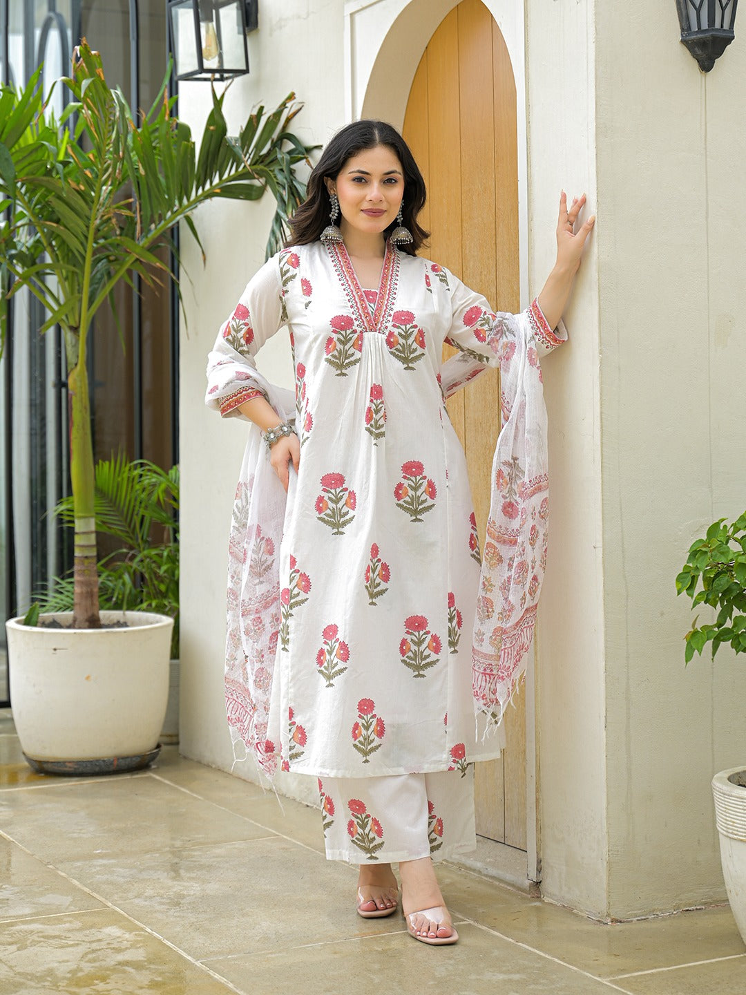 Woman wearing a white floral print cotton kurta set with dupatta in Indian ethnic style.