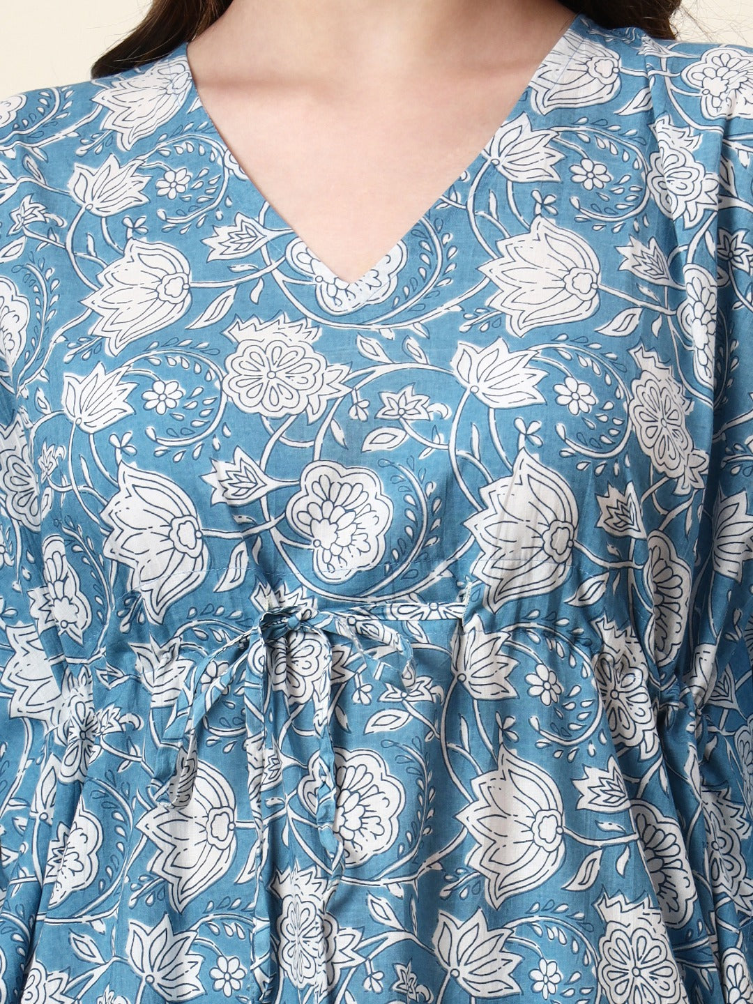 Close-up of a blue Indian ethnic dress with white floral block print and V-neckline.
