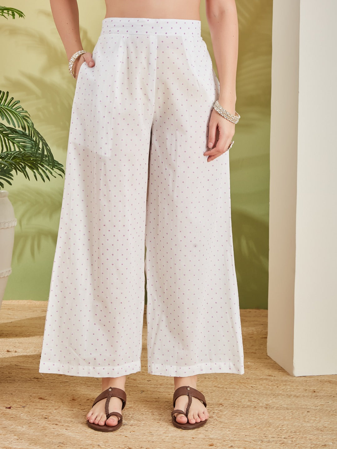 White wide-leg palazzo pants with small pink floral print for ethnic wear.